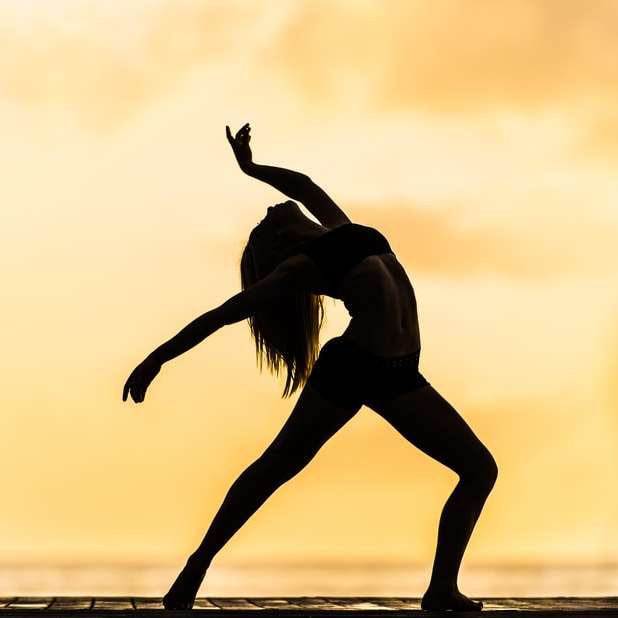 silhouette of woman making yoga pose online puzzle