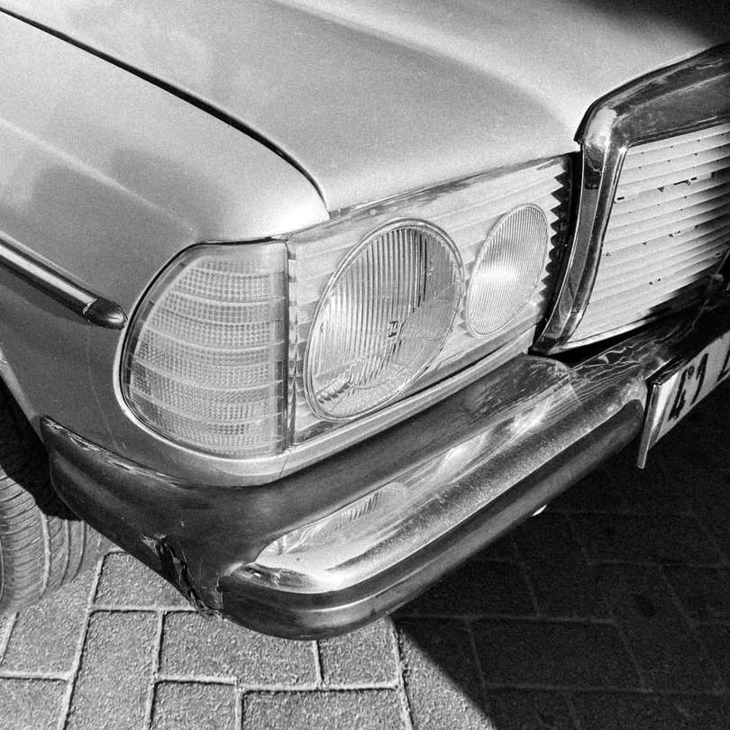 gråskalefoto av bil på tegelgolv glidande pussel online
