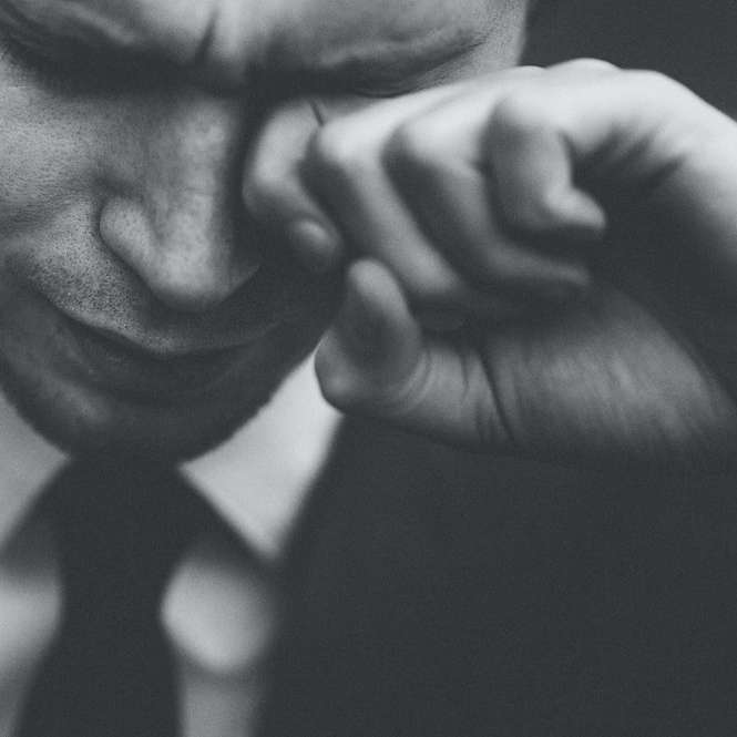 mężczyzna ocierający łzy puzzle przesuwne online