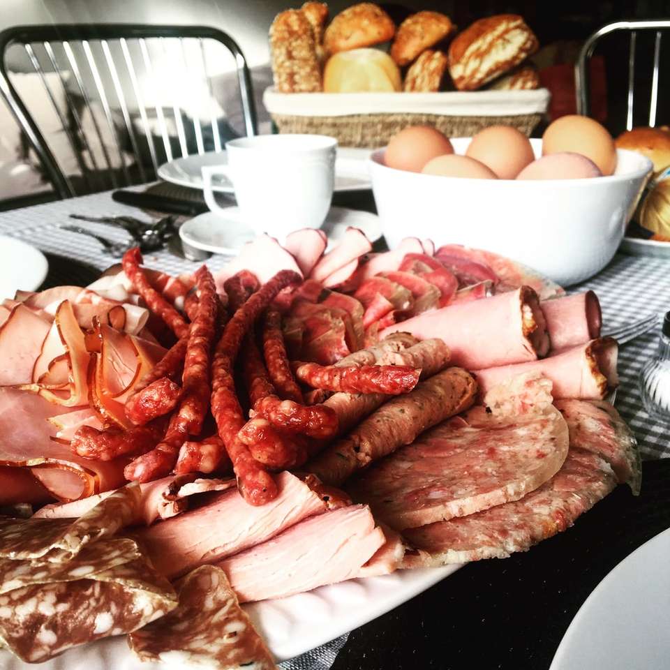 sausages near sliced ham beside chicken eggs in bowl sliding puzzle online