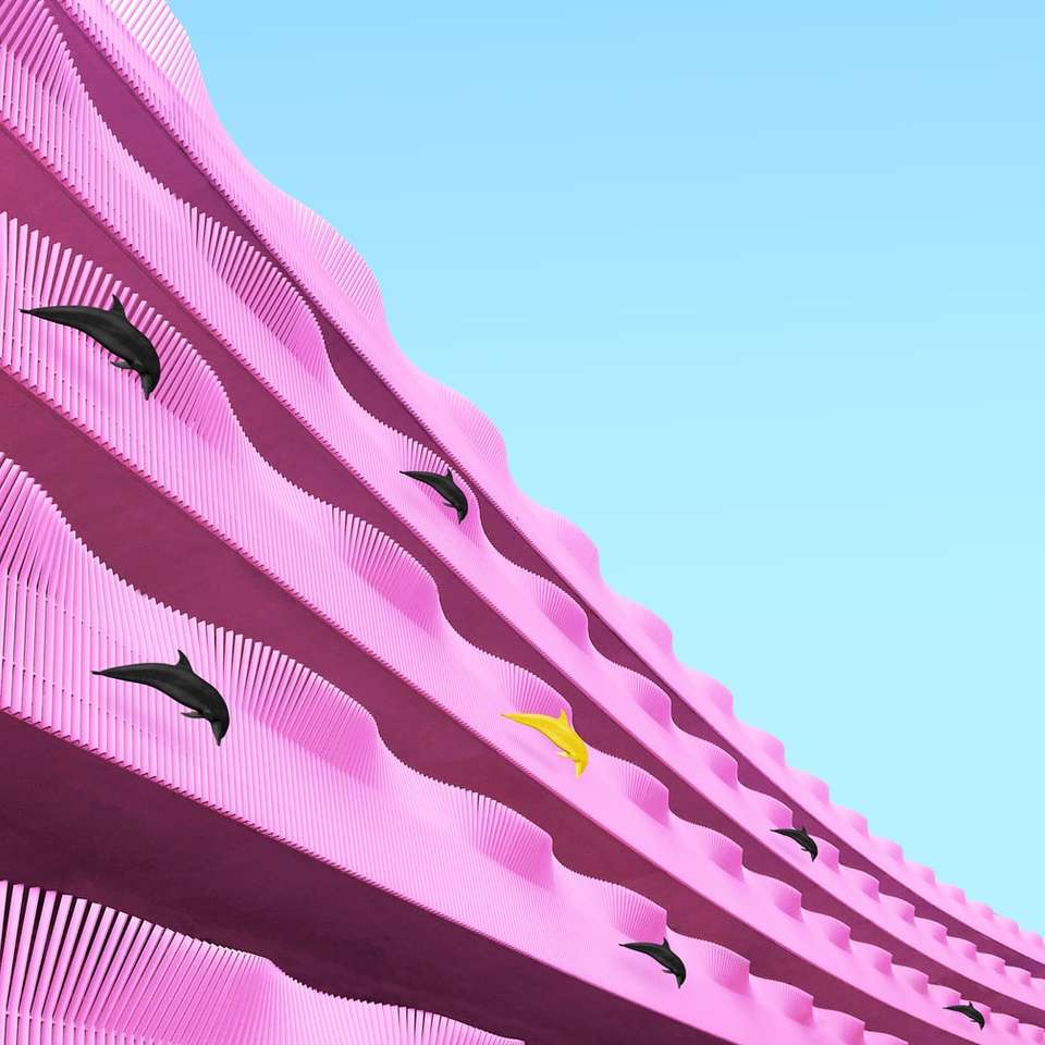 delfin hoppar på rosa yta Pussel online