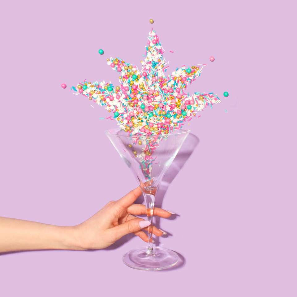 person holding clear martini glass sliding puzzle online