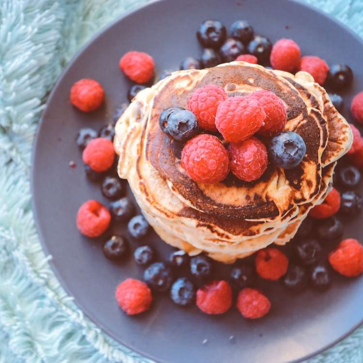 pancakes with blueberries and raspberries on gray plate online puzzle